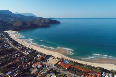 High angle view of sea and buildings against sky