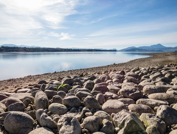 Rocks on beach against sky