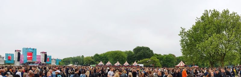 Group of people in city against sky