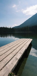 Pier over lake against sky