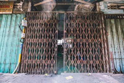 Metal fence by building in city