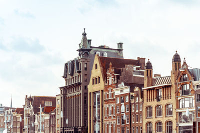 Buildings against cloudy sky