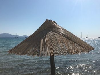 Built structure on beach against clear sky