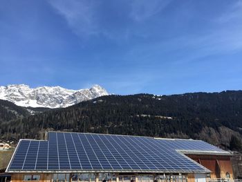 Solar panel against mountains and sky on sunny day