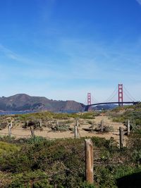 Bridge over mountain against blue sky