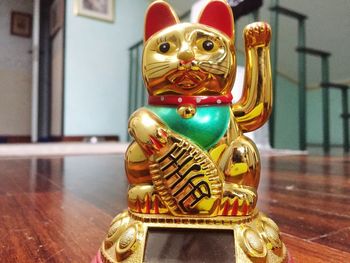 Close-up of buddha statue on table