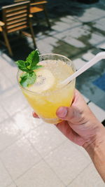 Cropped image of hand holding lemon juice