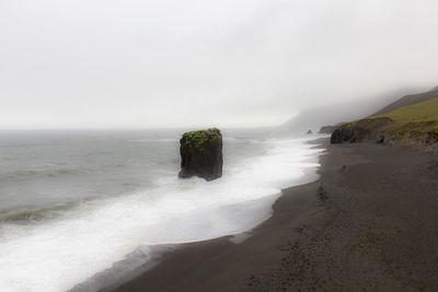 High angle view of sea with cliff