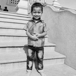 Portrait of smiling boy standing outdoors