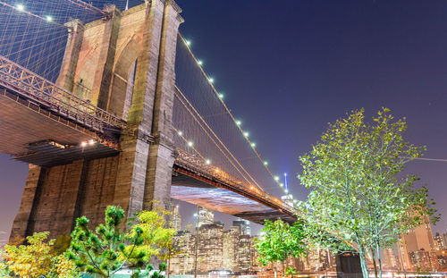 Low angle view of illuminated bridge at night