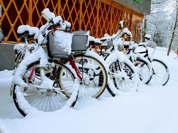 Bicycle parked on snow during winter