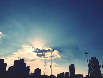 Low angle view of built structures against sunset