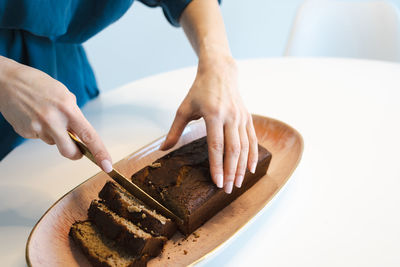 Woman cuts healthy banana bread