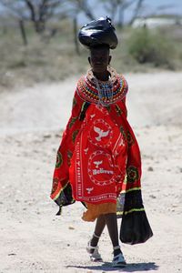 Woman walking traditional clothing walking on field