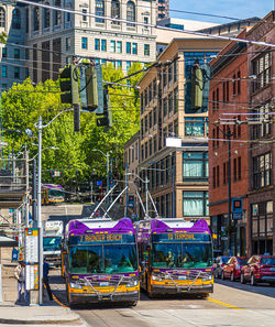 Cars on street by buildings in city