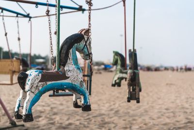 Close-up of amusement park ride on beach