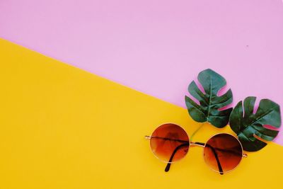 Directly above shot of sunglasses against yellow background