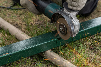 Man cutting iron road with machine