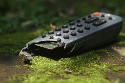 Close-up of remote control on field