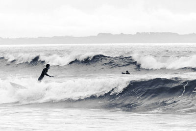 Men surfing in sea