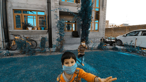 Portrait of girl against building