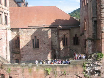People in front of building against sky
