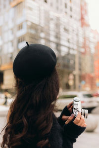 Rear view of woman using mobile phone