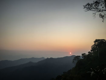 Scenic view of silhouette mountains against sky during sunset