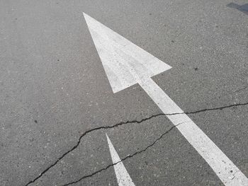 High angle view of arrow sign on road