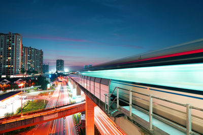 Blurred motion of train in city against sky