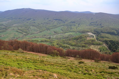 Scenic view of landscape and mountains against sky