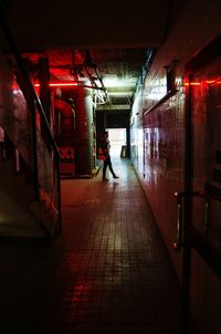 Full length of woman in illuminated tunnel