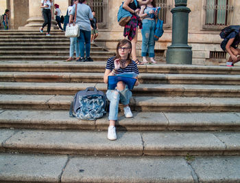 High angle view of people sitting on staircase