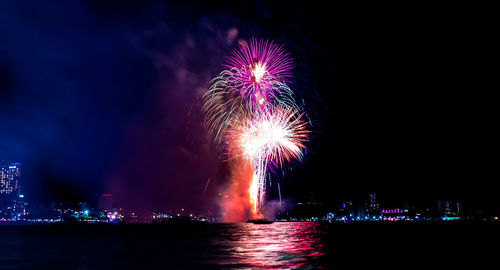 Firework display in city at night