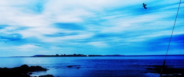 Scenic view of sea against cloudy sky