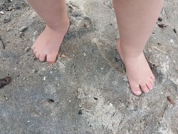 Low section of woman standing on tiled floor