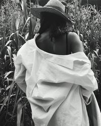 Rear view of woman standing on field