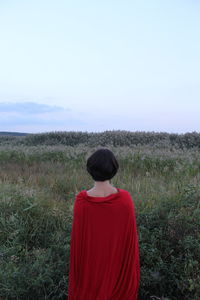 Rear view of woman standing on field