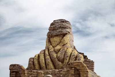 Close-up of weathered sculpture representing dakar rally