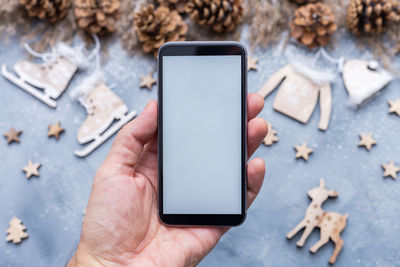 Close-up of person using mobile phone on table