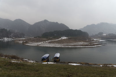 Scenic view of lake and mountains against sky