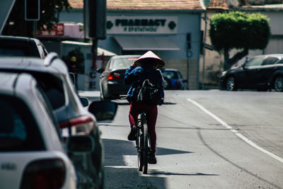 Rear view of man walking on city street