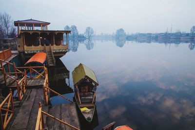 Built structure in lake against sky