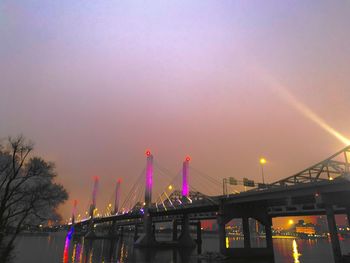 Illuminated bridge against sky during sunset