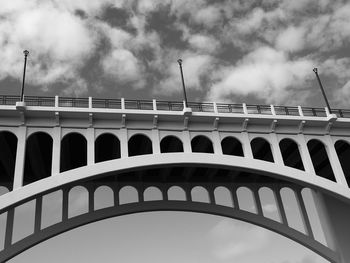 Low angle view of arch bridge against sky