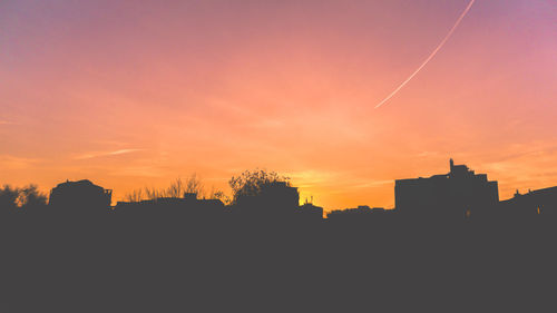 Low angle view of building against sky at sunset