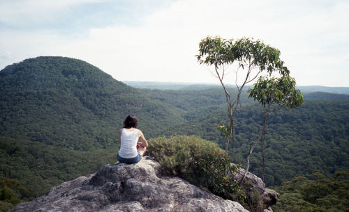 Rear view of woman standing on mountain