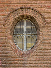 Low angle view of window on brick wall of building