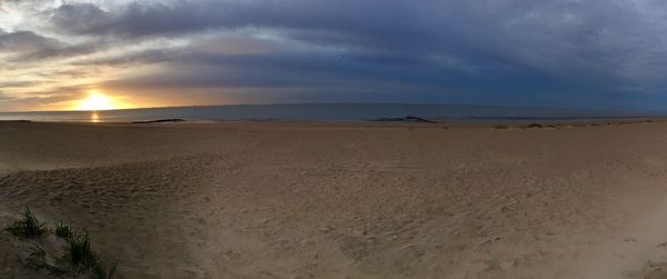 Scenic view of beach against sky during sunset