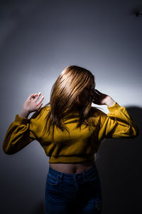 Woman standing against gray background